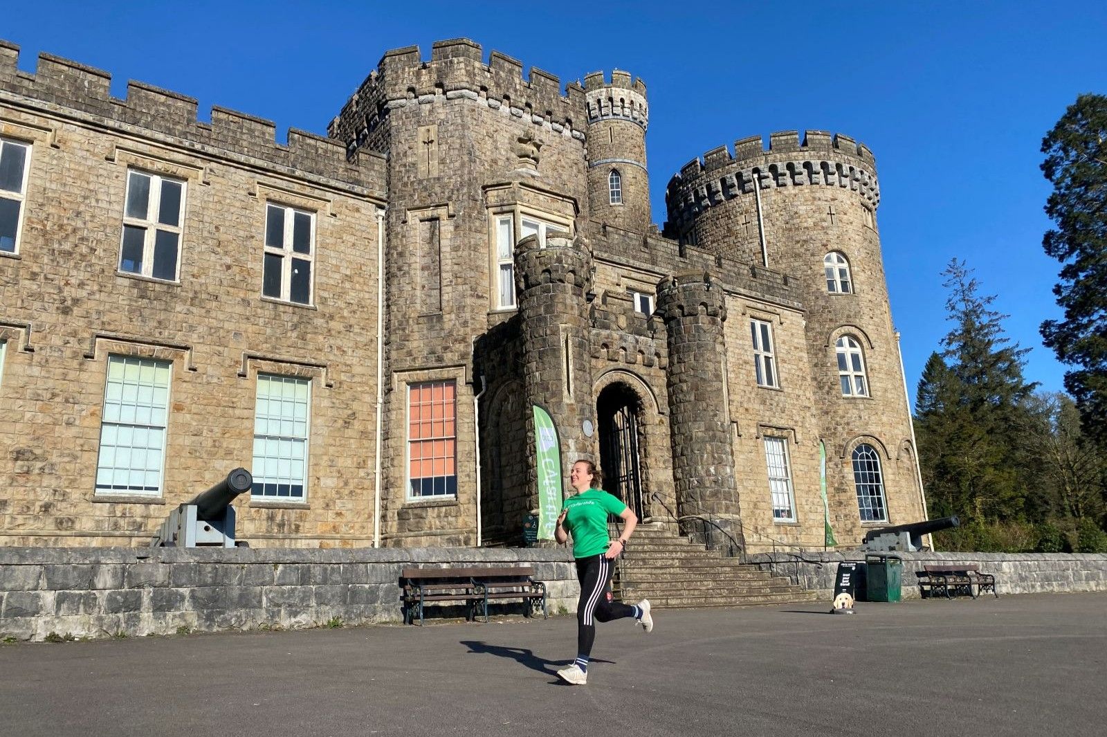 Woman in green T-shirt running with Cyfarthfa Castle in the background.JPG