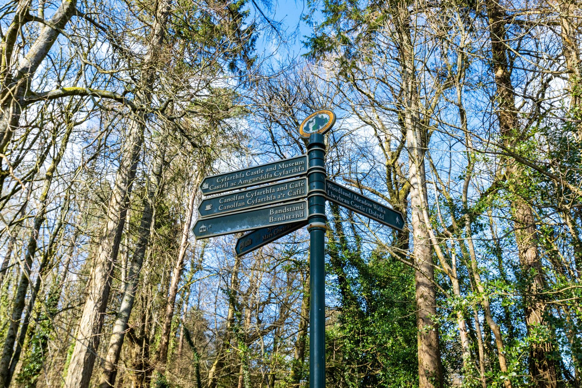A signpost in Cyfarthfa surrounded by trees.jpg