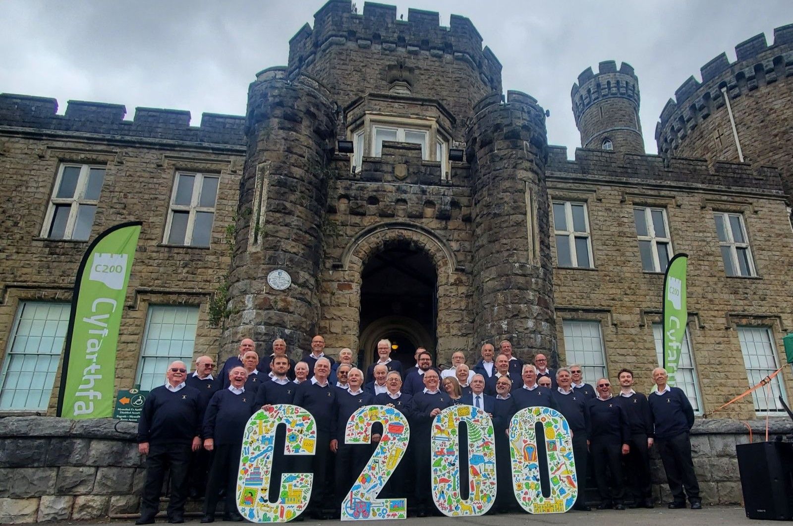 Dowlais Male Choir with C200 letters in front of Cyfarthfa Castle.jpg