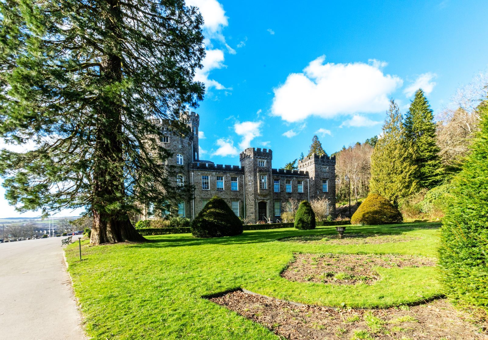 Cyfarthfa Castle with a large garden and tree.jpg